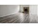 Living room features hardwood floors and a stone fireplace at 703 Pine Tree Trl, Atlanta, GA 30349
