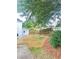 Landscaped backyard with retaining wall and wooden fence at 540 Langley Creek Dr, Loganville, GA 30052