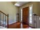 Bright entryway with hardwood floors and wooden staircase at 1260 Sweet Woods Dr, Lawrenceville, GA 30044