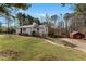 White ranch house with red door, detached shed, and large yard at 294 William Bobo Dr, Canton, GA 30115