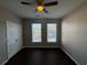 Bedroom with double door closet and two windows with blinds at 3230 Mill Springs Cir, Buford, GA 30519