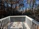 White deck overlooking a wooded area at 3230 Mill Springs Cir, Buford, GA 30519