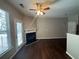Living room with fireplace, dark hardwood floors, and patio access at 3230 Mill Springs Cir, Buford, GA 30519