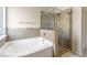 Bathroom with corner soaking tub and a glass shower at 617 Ocean Ave, Canton, GA 30114