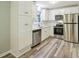 Modern kitchen with white cabinets and stainless steel appliances at 1864 Fairburn Sw Rd, Atlanta, GA 30331