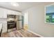 Modern kitchen with white cabinets and stainless steel appliances at 1864 Fairburn Sw Rd, Atlanta, GA 30331