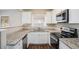 Modern kitchen with white cabinets, granite counters and stainless steel appliances at 245 Bromack Se Dr, Atlanta, GA 30315