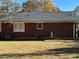 Brick home with a large backyard and central AC unit at 4685 Ruby Ln, Forest Park, GA 30297