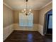 Formal dining room with hardwood floors and a chandelier at 1256 St James Pl, Loganville, GA 30052