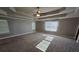 Large main bedroom with tray ceiling and carpet at 1256 St James Pl, Loganville, GA 30052