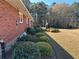 Brick home with landscaped backyard and large grassy area at 2566 N Hightower Trl, Conyers, GA 30012