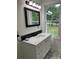 Modern bathroom with white vanity, quartz countertop, and marble tile at 5510 Mason Rd, Atlanta, GA 30349