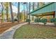 Landscaped backyard with concrete pathway and patio at 7546 Palmetto Way, Riverdale, GA 30274