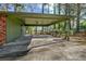 Covered carport with concrete flooring and access to the backyard at 7546 Palmetto Way, Riverdale, GA 30274