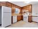 Updated kitchen with white appliances and wood cabinetry at 7546 Palmetto Way, Riverdale, GA 30274