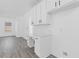 White kitchen with built-in desk and hardwood floors at 4480 Greycliff Pointe, Douglasville, GA 30135