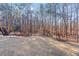 Spacious, fenced backyard with trees and a wooden deck and stairs at 1440 Tamarack Way, Alpharetta, GA 30005