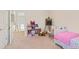 bedroom with pink bedspread, storage, and a desk at 1440 Tamarack Way, Alpharetta, GA 30005