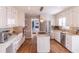 Modern kitchen with white cabinets, granite counters, and stainless steel appliances at 1721 Berry Ln, Snellville, GA 30078