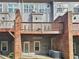 Rear exterior view of the home showing the deck and patio below at 1690 Mosaic Way, Smyrna, GA 30080