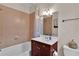 Bathroom with tub/shower combo, tile walls, and wood vanity at 1690 Mosaic Way, Smyrna, GA 30080