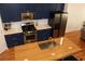 Close-up of the modern kitchen's island with sleek sink, butcher block countertop, and gold faucet at 1690 Mosaic Way, Smyrna, GA 30080