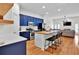 Modern kitchen featuring blue cabinetry, a butcher block island, and stainless steel appliances at 1690 Mosaic Way, Smyrna, GA 30080