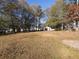 Large backyard with detached garage and mature trees at 5078 Paris Ave, Powder Springs, GA 30127