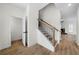 Modern staircase with black spindles and light wood steps at 237 Harmony Woods Dr, Dallas, GA 30157