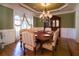 Formal dining room featuring hardwood floors, a large table, and a built-in hutch at 3032 Canton View Walk, Marietta, GA 30068