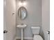 Small powder room with pedestal sink and oval mirror at 2343 Buford Town Dr Dr, Buford, GA 30518