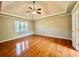 Spacious main bedroom with hardwood floors and ceiling fan at 3210 Woolbridge Ln, Marietta, GA 30062