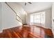 Living room with a bay window, hardwood floors, a fireplace, and a staircase at 3480 Park Bluff Ln, Duluth, GA 30096