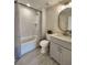 Modern bathroom with a white tub, gray vanity, and tiled floor at 6615 Callanwalde Ct, Suwanee, GA 30024