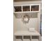 White bench with cubbies and hooks, perfect for entryway at 6615 Callanwalde Ct, Suwanee, GA 30024