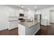 Modern kitchen with white cabinets, granite island, and stainless steel appliances at 208 Paulownia Cir, Mcdonough, GA 30253