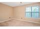 Empty bedroom with carpeted floor and window at 310 Butler Bridge Cir, Covington, GA 30016