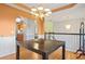 Dining room with dark wood table, chandelier, and view of adjacent living area at 310 Butler Bridge Cir, Covington, GA 30016