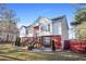 Two-story house with red brick and white siding, landscaping, and a wooden staircase at 310 Butler Bridge Cir, Covington, GA 30016