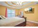 Spacious main bedroom with laminate floors and a ceiling fan at 310 Butler Bridge Cir, Covington, GA 30016