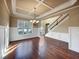 Spacious dining room with hardwood floors and a view of the staircase at 4026 Rotterdam Pass, Hampton, GA 30228