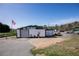 Commercial building with large roll-up door and ample parking at 1793 Johnson Road, Cumming, GA 30040