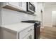 Modern kitchen with white cabinets and hexagon backsplash at 913 Agate Ln, Lawrenceville, GA 30043