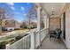 Covered porch with seating area overlooking the street at 5184 Dovecote Trl, Suwanee, GA 30024