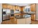 Kitchen with island, stainless steel appliances, and wood cabinets at 5184 Dovecote Trl, Suwanee, GA 30024