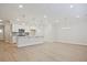 Modern kitchen with white cabinetry, large island, and stainless steel appliances at 905 Agate Ln, Lawrenceville, GA 30043