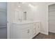 Double vanity bathroom with white cabinets and gray tile floors at 907 Agate Ln, Lawrenceville, GA 30043