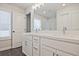 Double vanity bathroom with white cabinets and gray tile floors at 907 Agate Ln, Lawrenceville, GA 30043