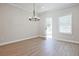 Luminous dining room features hardwood floors, chandelier, and access to back patio at 907 Agate Ln, Lawrenceville, GA 30043