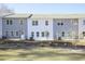 Rear view of townhouses with gray and white siding at 907 Agate Ln, Lawrenceville, GA 30043
